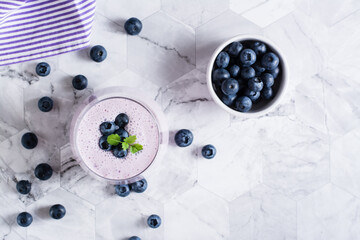 Smoothies with blueberries and mint in a glass on the table. Antioxidant organic diet food. Top view