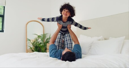 Happy, child and father on bed for airplane games, support and relax for fun together in family home. Dad, boy kid and excited to fly for freedom, fantasy and balance to imagine play, trust or energy