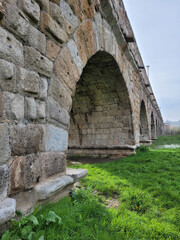 side view of the arches of the Roman bridge over the Tormes river in Salamanca