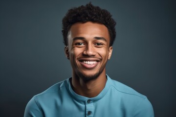 Obraz premium A man smiling and wearing a blue shirt