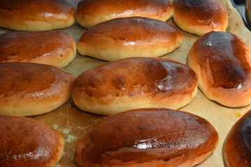 Pies with filling on a baking sheet.