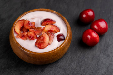 fresh yogurt with cherry flavor and whole juicy cherry berries