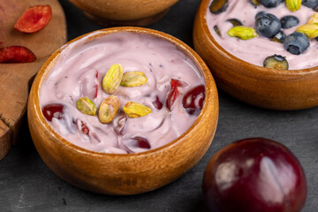 fresh blueberry-flavored yogurt with ripe cherries and pistachios