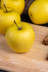 yellow ripe apple with cinnamon on the table