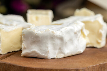 Fototapeta na wymiar delicious white cheese sliced on a board