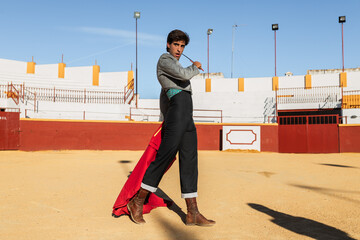 Male matador performing with red cloth