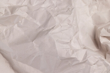 gray low-quality crumpled paper from recycled waste paper