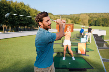 Obraz premium Fairway Fun: Young Golfers in Action
