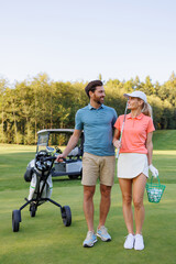 Obraz premium Stylish Couple Golfing with Scenic Background