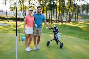 Fototapeta premium Golfing Duo by Final Flag with Club Equipment