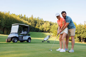 Fototapeta premium Last Hole Joy: Young Couple Golfing