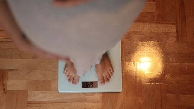 big belly top view. Pregnant girl on the scales. Concept of weight gain and proper nutrition during pregnancy