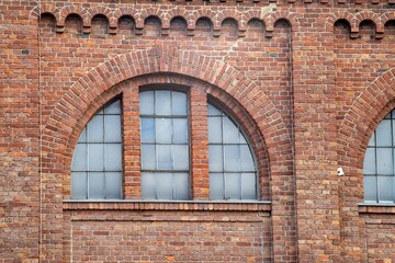 old window in a brick wall of an industrial nearly 100 years old buiding