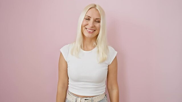 Young blonde lady, comically standing over isolated pink background, making crazy fish face gesture! fun, funny expression plastered on lips