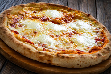 Margherita Pizza with tomato sauce and mozzarella cheese  on wooden background
