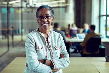 Smiling portrait confident happy senior businesswoman in office