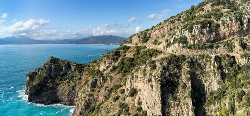 Fototapeta na wymiar landscape view of the Costa di Maratea with a narrow and winding coastal highway in the cliffside