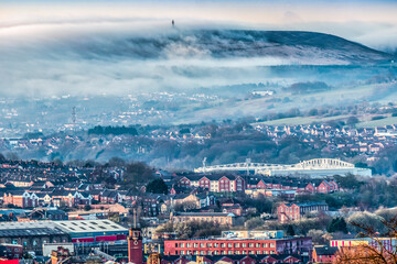 Blackburn Town with Fog & Mist over Darwen Moors