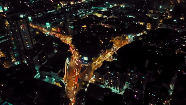 Aerial view of Mumbai City at night during Diwali, with twinkling lights decorating the city. Shot of fast-moving city traffic and the evening skyline with shining city lights.  