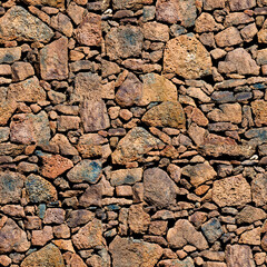  Cracked stone wall in arid climate with rough textured rock.