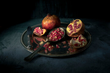 Chiaroscuro still life of pomegranates © lleandralacuerva
