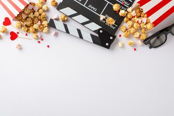 Love is in the air on Valentine's Day: Top view clapperboard, 3D glasses, popcorn, heart decor,...