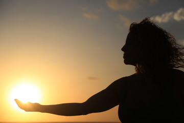 Fototapeta premium woman meditation and yoga poses in the beach with sunrise