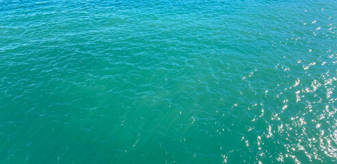 Turquoise sea water surface texture background. Top view of the sea.