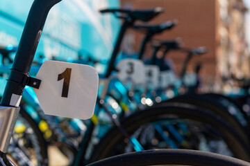 Bib number 1 on a competition bicycle with more bicycles out of focus in the background before...