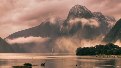 Photograph looking into Milford Sound on a cloudy and rainy day from the boat harbour in Fiordland...