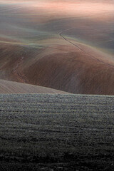 lights and shadows on the plowed fields showing sinuous and sweet shapes
