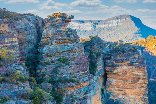 Photograph of the rugged and rocky cliff face of mountains the Megalong Valley in the Blue Mountains in New South Wales in Australia