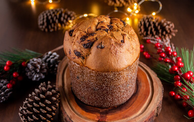 Traditional Italian panettone with chocolate for Christmas on wooden table.