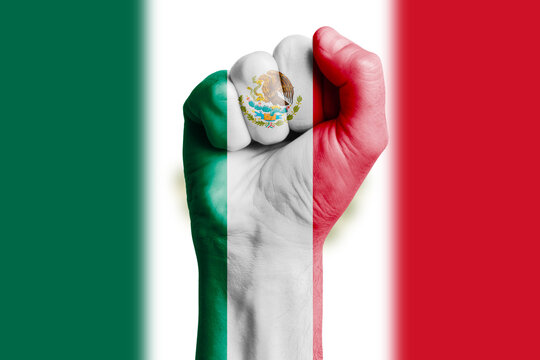 Man hand fist of MEXICO flag painted. Close-up.