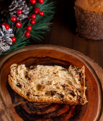 Slice of delicious Panettone with chocolate for Christmas. On wooden table