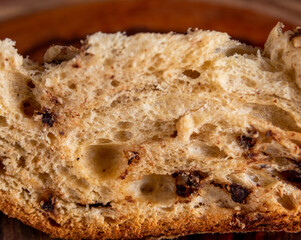 Slice of delicious Panettone with chocolate for Christmas. On wooden table