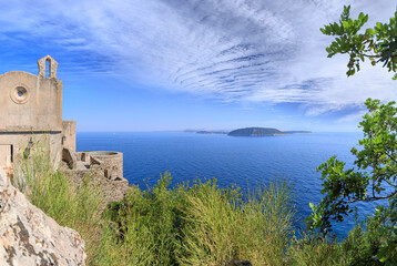 View of the coast of Procida from a suggestive medieval architecture on the Ischia island, Italy.