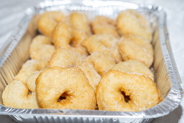 Delectable Fresh Hot Donuts, Glistening with Sugar on a Disposable Silver Foil Baking Pan. Sfenj, Popular Moroccan Doughnuts, Are Enjoyed in Israel During Both Hanukkah and Mimouna Celebrations.