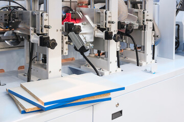 Wood boards on a woodworking machine in a modern furniture factory, woodworking industrial concept background