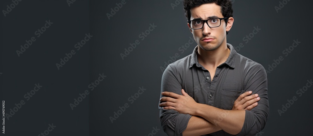 Poster young hispanic man wearing casual clothes and glasses skeptic and nervous disapproving expression on