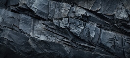Black rock texture background. Rough mountain surface with cracks. Black stone background with space for design