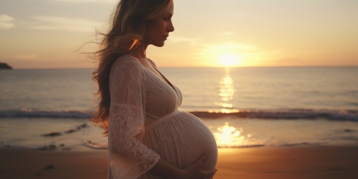 A beautiful pregnant woman standing on a beach at sunset. This image can be used to depict the serenity and beauty of pregnancy or as a symbol of hope and new beginnings.