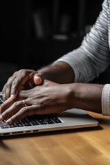 Obraz premium A person is seen typing on a laptop computer. This image can be used to depict technology, work, productivity, remote work, or education