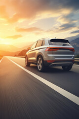 Fototapeta na wymiar A silver SUV is seen driving down a highway during a picturesque sunset. This image can be used to depict travel, adventure, road trips, or transportation