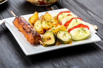 kebab on sticks served with vegetables