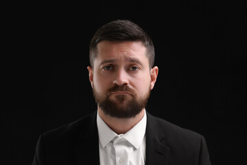 Personality concept. Sad man on black background