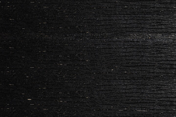 A black wooden board with grain. Vector wood texture background