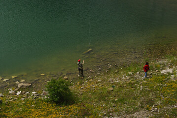 Fototapeta premium Fishing in Campotosto lake. Abruzzo, Italy
