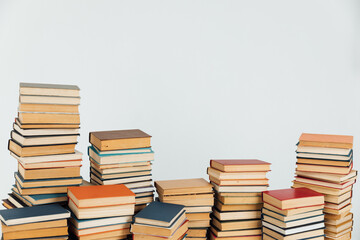 Stacks of educational books in university library on white background