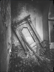 view to broken door of altar in abandoned church in vintage style